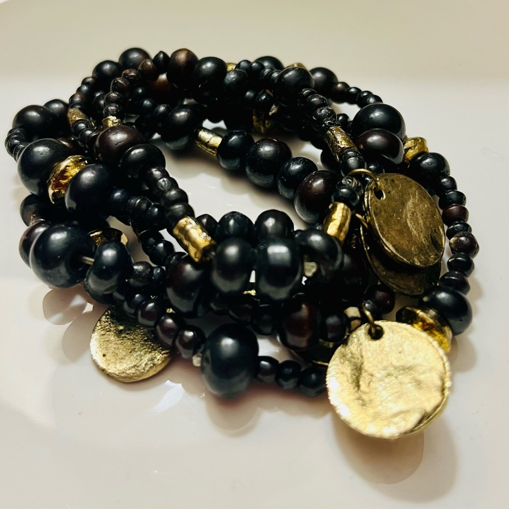 Five stacked bracelets black and gold-tone